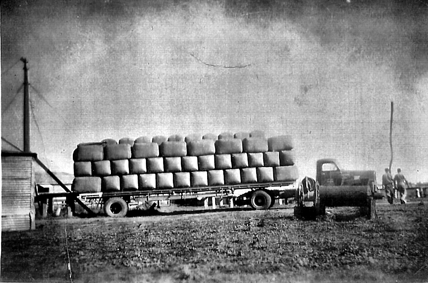 Truck at the loading bay, stacked with pressed bales