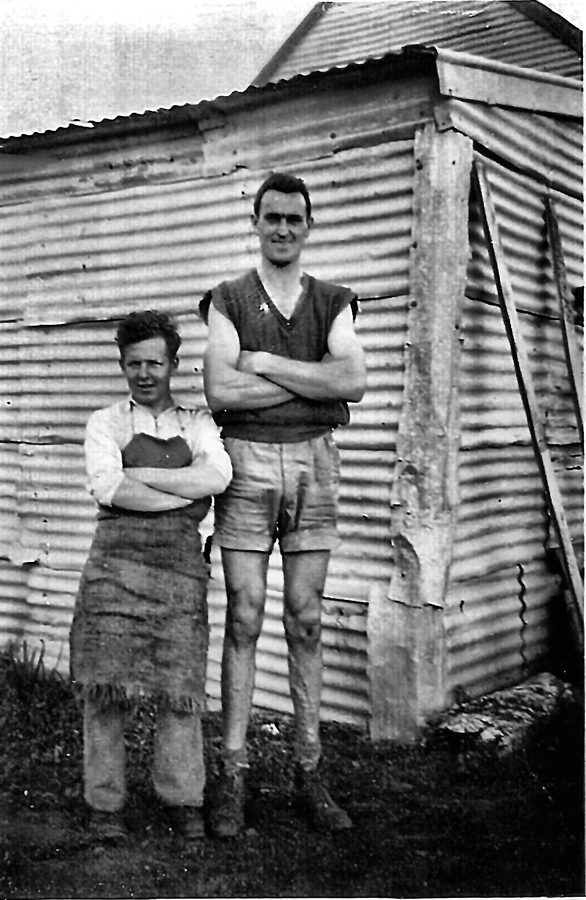Arthur Smith (left) with a tall companion outside a tin shed at Toganmain, July 1955