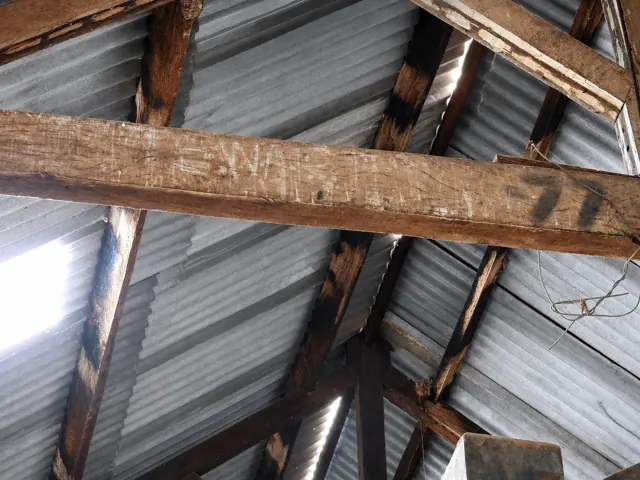 Stencilled 77 in the shed rafters